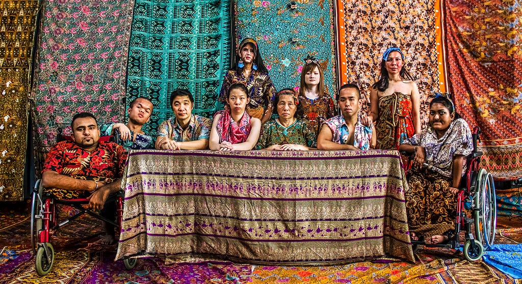 True Complexion community members shot in a batik-patterned backdrop and clothing pieces