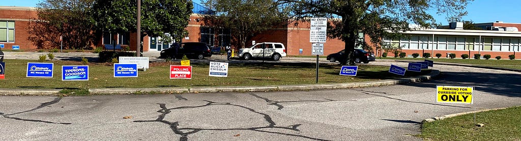Campaign and informational signs outside a school that is serving as a polling place.