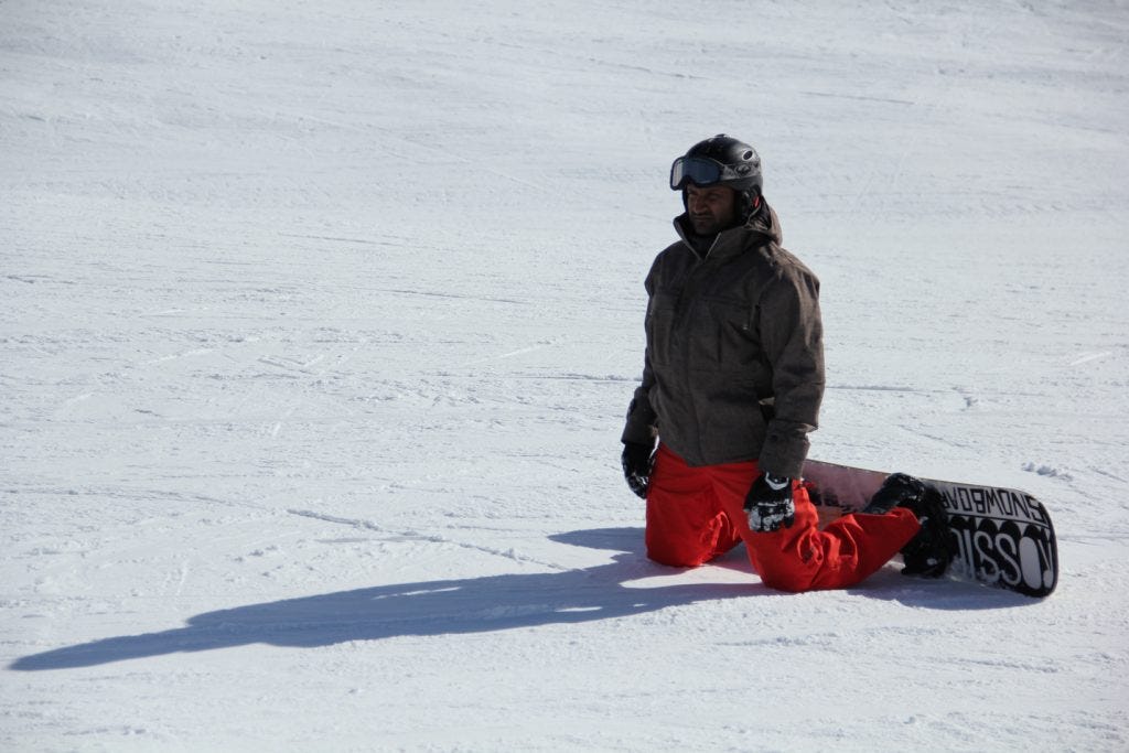 Niraj on a snowboard