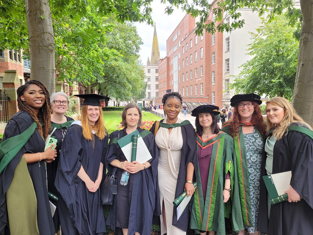 A group photo of Professional Studies students celebrating graduating from the University of Leeds in July 2024, alongside their tutors and including Hannah.