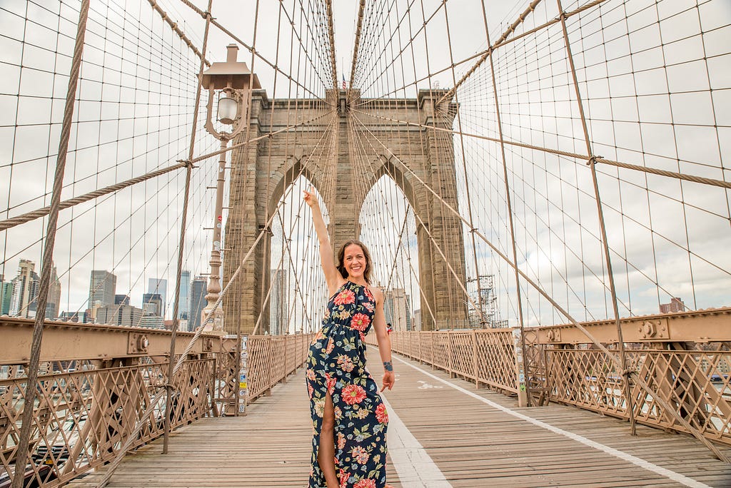 woman posing on the Brooklyn Bridge of NYC