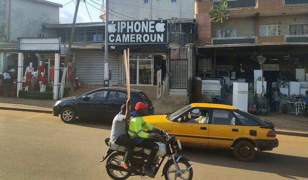 Shopping street with a shop called “iPhone Cameroun”