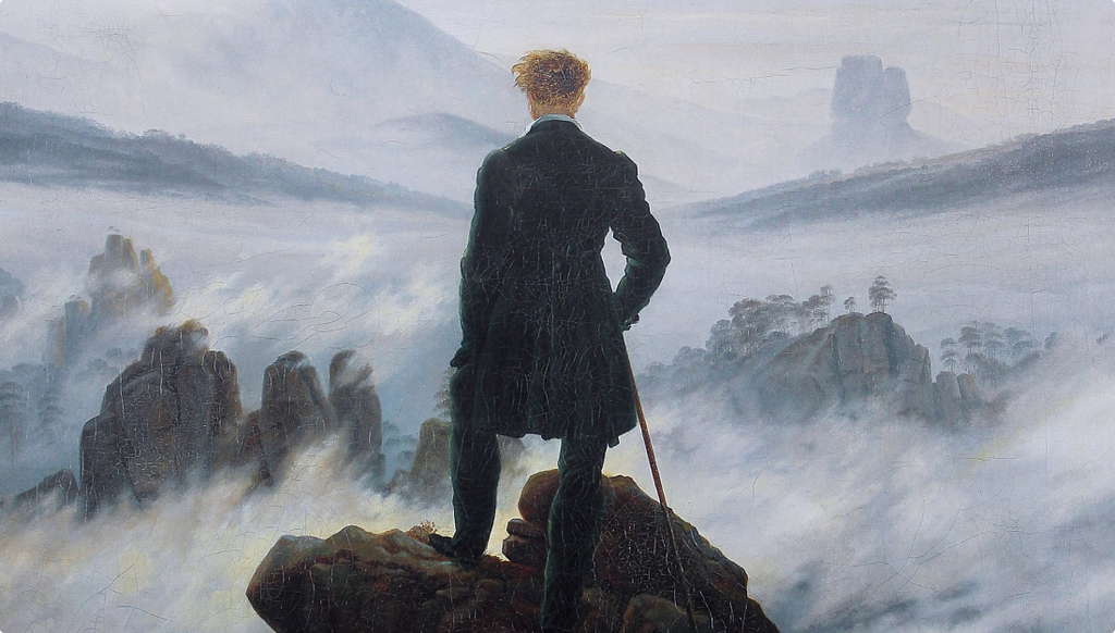 A Romantic oil painting showing a lone figure in a dark coat standing on a rocky outcrop, viewed from behind, gazing out over a vast misty landscape of mountains and fog.