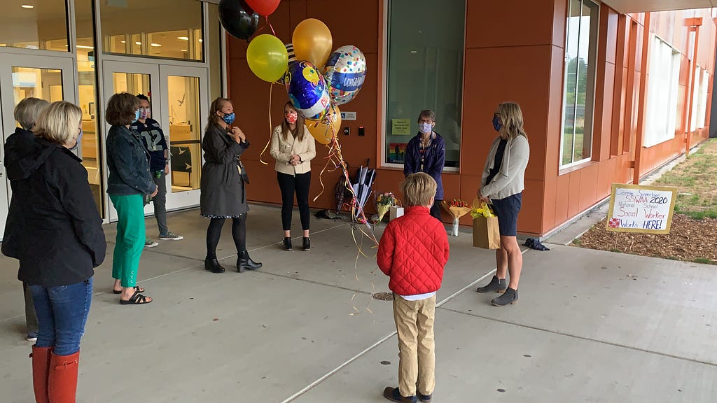 Syvertsen and colleagues celebrate in front of Robert Eagle Staff Middle School