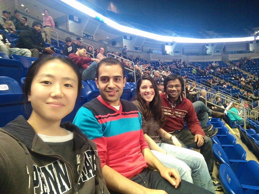 Alsayed at a sports stadium with friends.