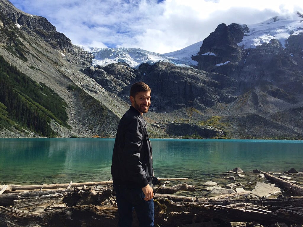 Gilad from Anxious & Abroad takes a photo at Joffree Lake in British Columbia, Canada with glaciers and mountains