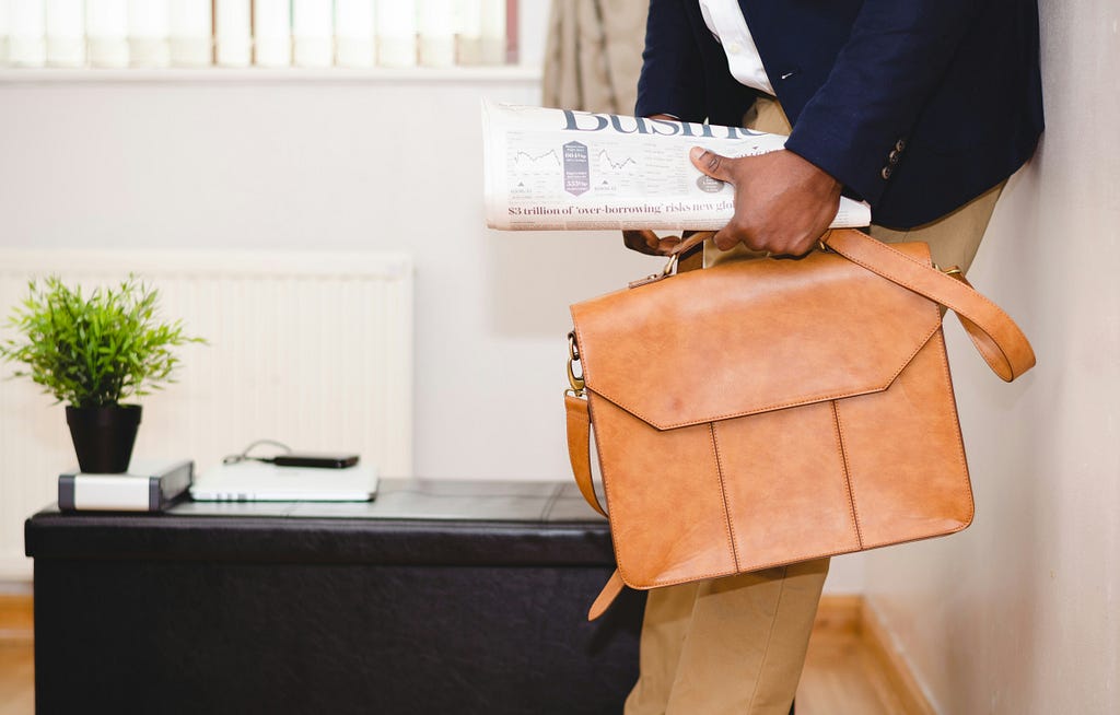 Someone going to work and holding business newspapers (Image is only for esthetism and not related to the article)