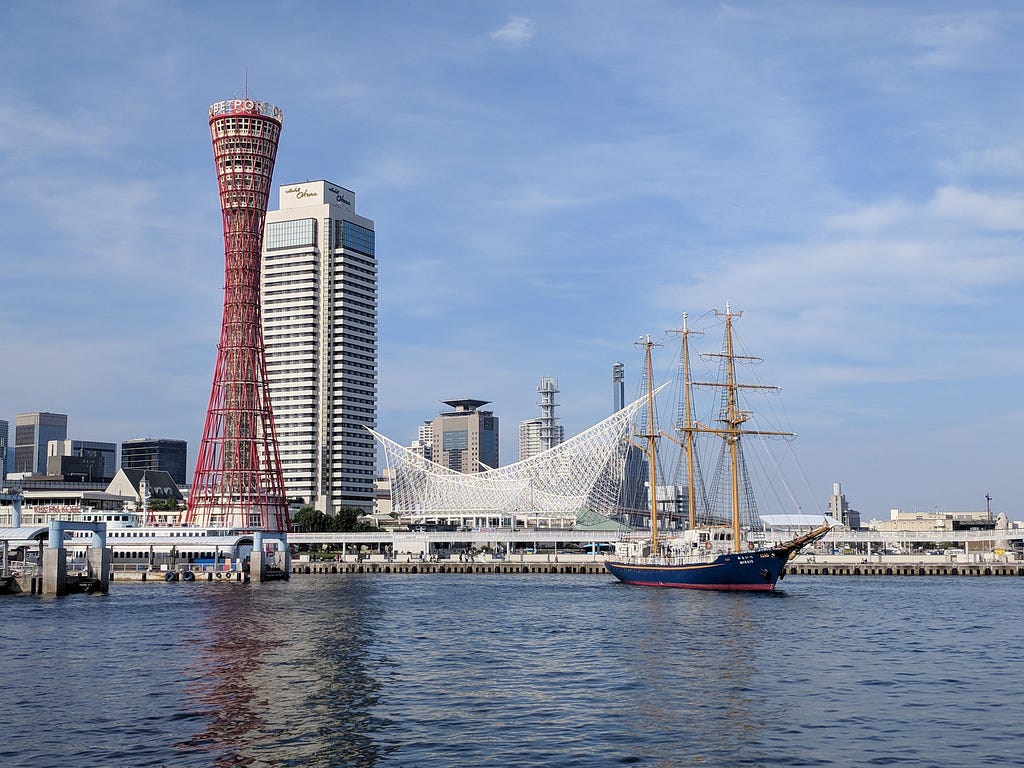Kobe’s harbor area, with Port Tower, and a ship in the water.
