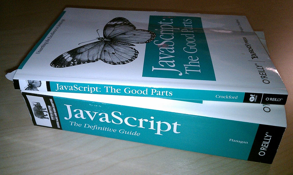 Two O’Reilly Programming Books- the first is “JavaScript: The Definitive Guide” and is roughly three inches thick; the second is “JavaScript: The Good Parts” and it is only about one inch thick.