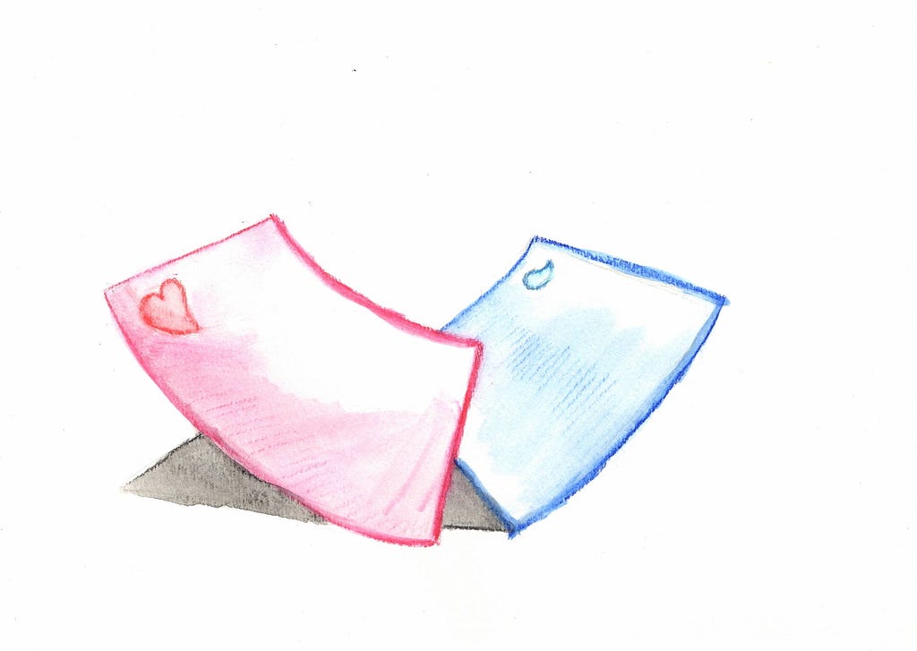 Two pieces of paper, one colored red with a heart, and the other colored blue with a teardrop.