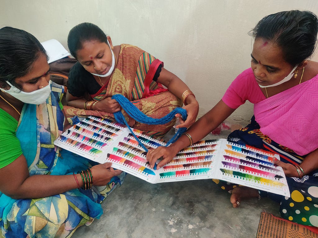 Women confirm yarn colors at a training focused on quality control organized by Chitrika in Narayanpet.