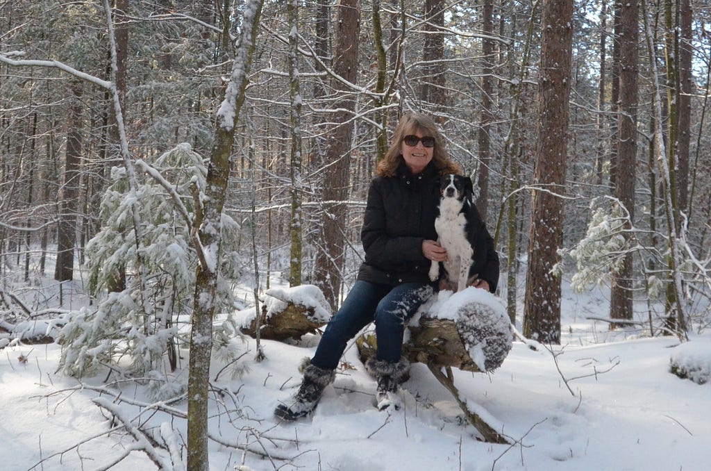 Woman with Dog in snow. Photo by Sheila Sharpe-Beasley