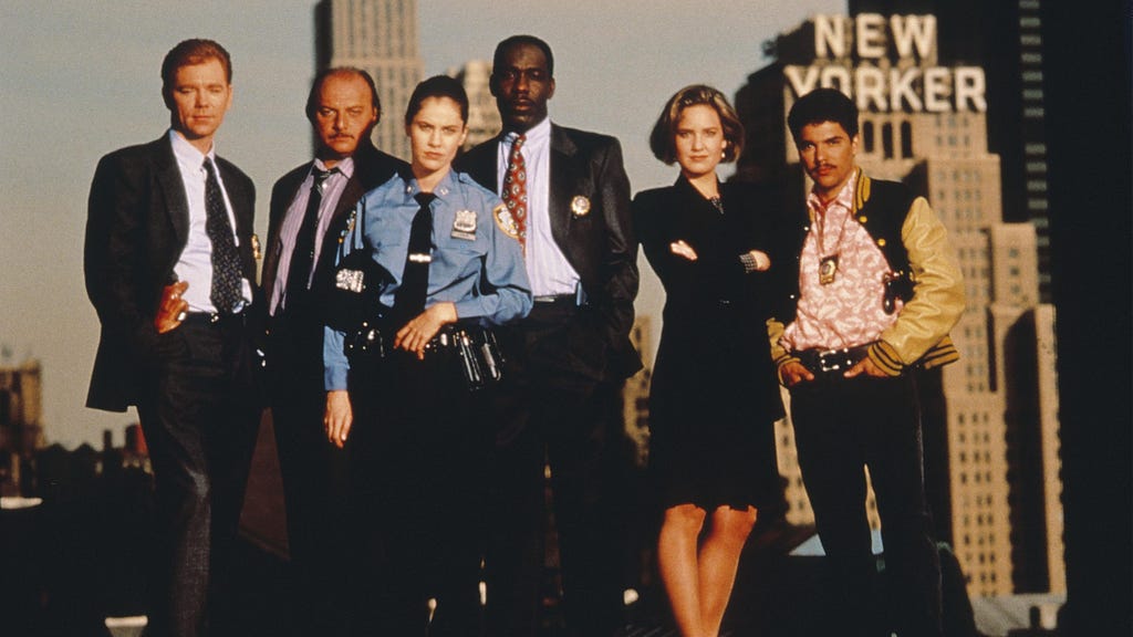 A group of police officers and detectives standing against the New York skyline