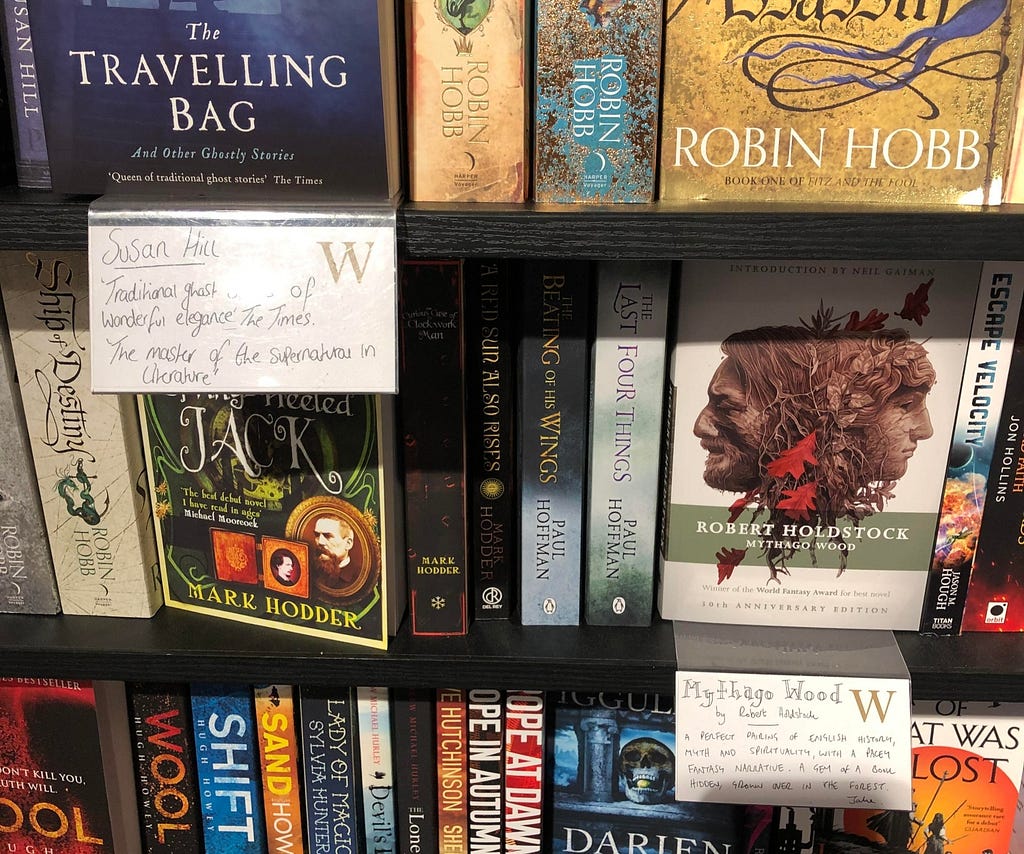 Books on a shelf in Waterstones with staff notes in front of a couple of books