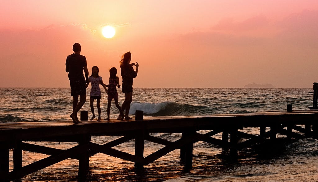 family of four with two daughters strolling before a turbulent sea.