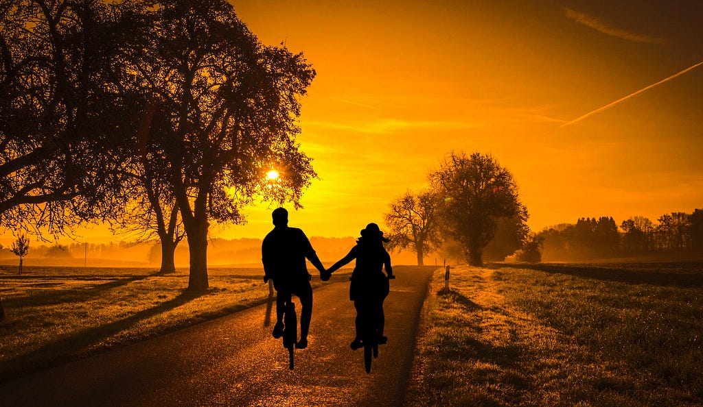 Couple riding bikes.