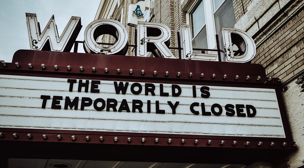 Photo of a Cinema front displaying “The World is temporarily closed”