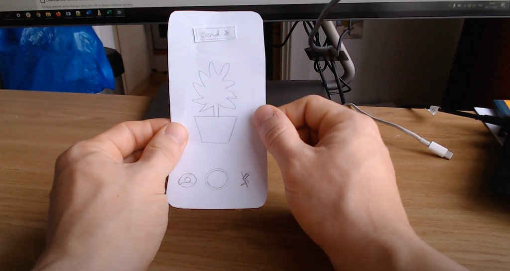 Screenshot of video recording of user testing the paper prototype