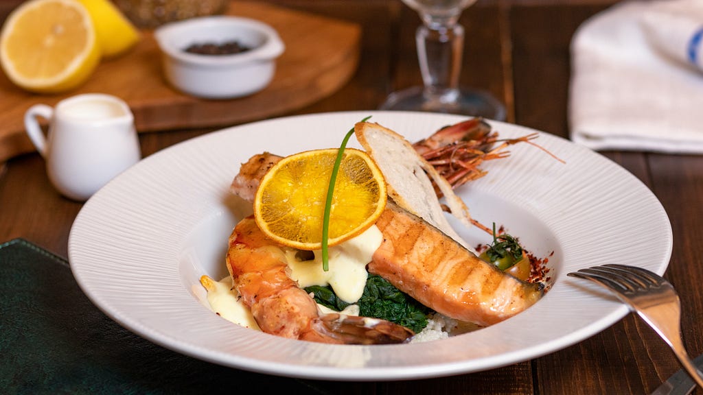 A plate of seafood meal served at a restaurant