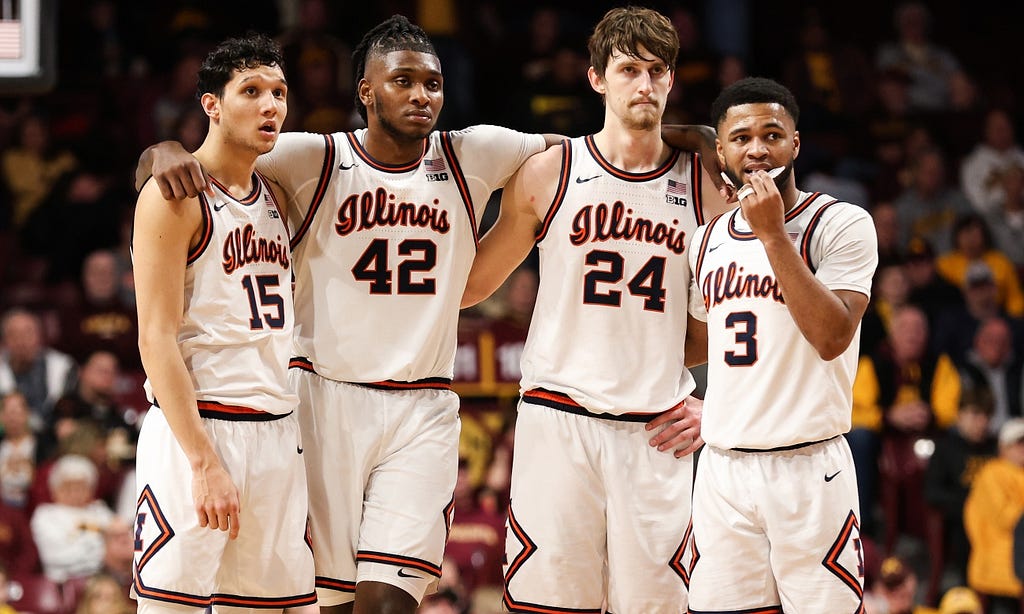 RIGHT TO LEFT: RJ Melendez, Dain Dainja, Matthew Mayer, and Jayden Epps stand locking shoulders during a game for the Illinois Fighting Illini.