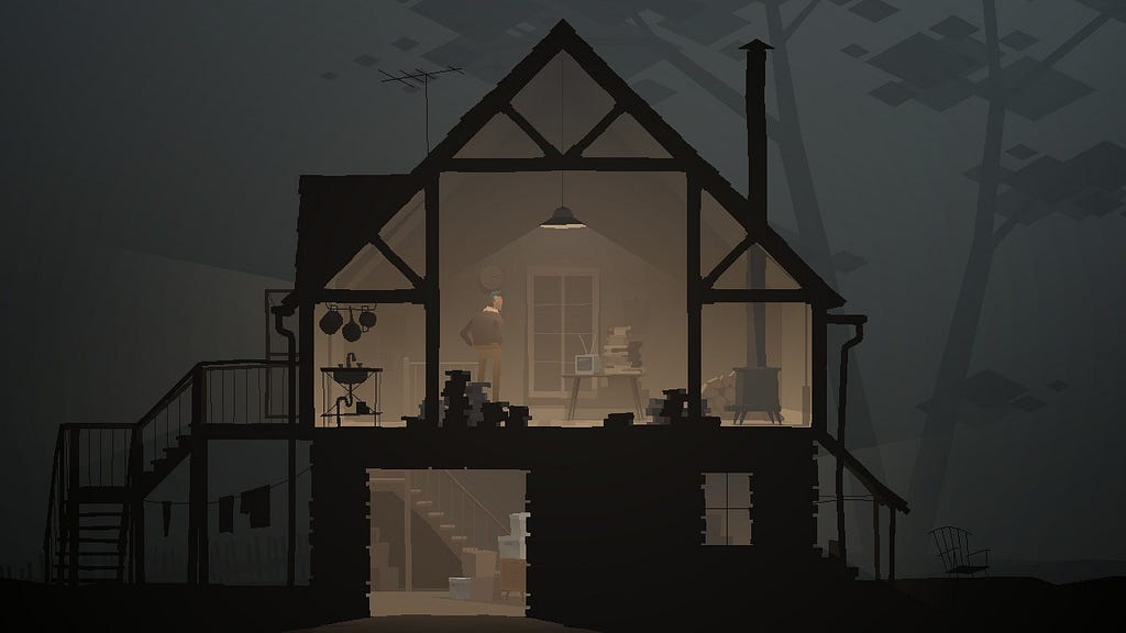 A man stands inside of a small, dimly lit cabin. The cabin appears to be in the middle of a sparse and foggy forest.
