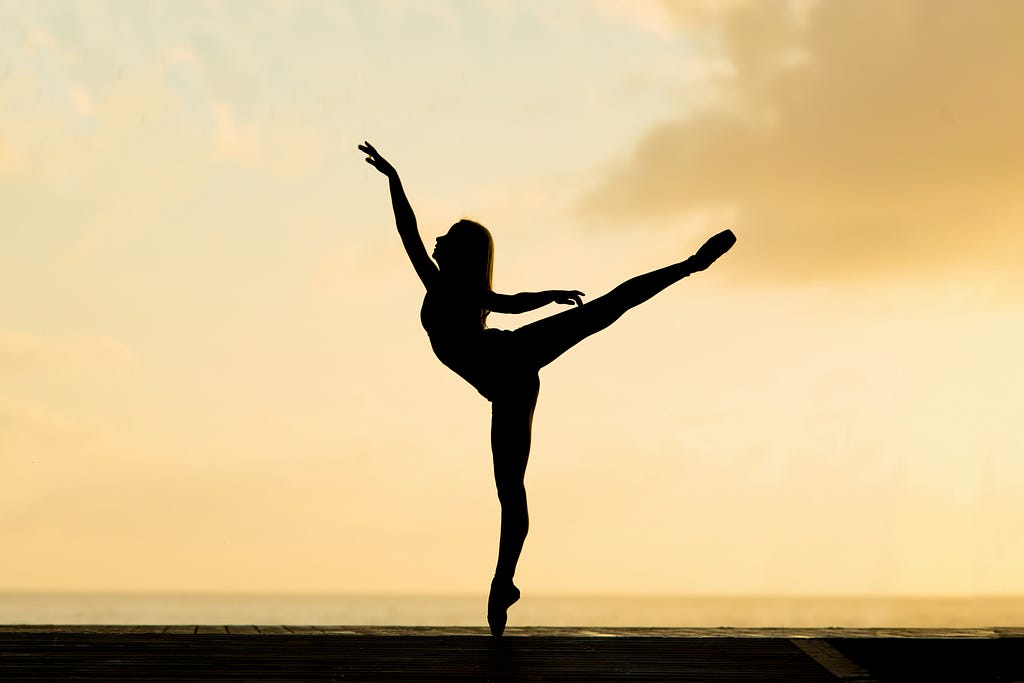 Dancer, ballerina, orange sky background behind