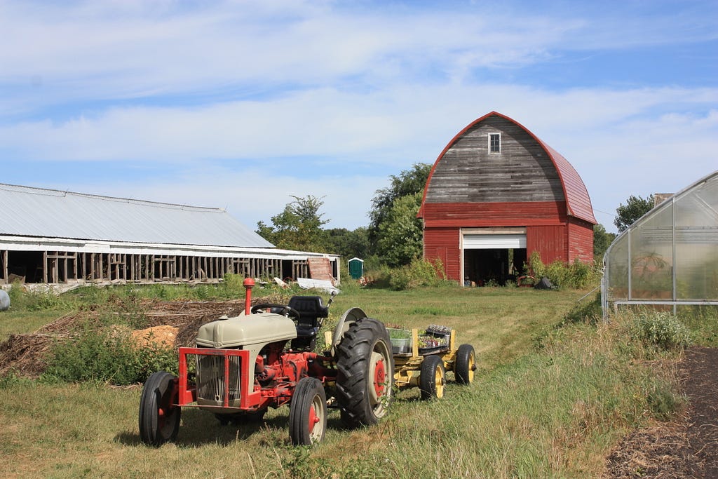 farm with old tractor, granary, high tunnel