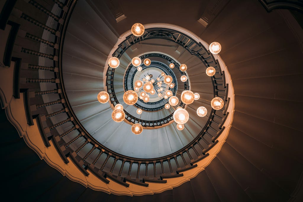 Spiral staircase with hanging light bulbs