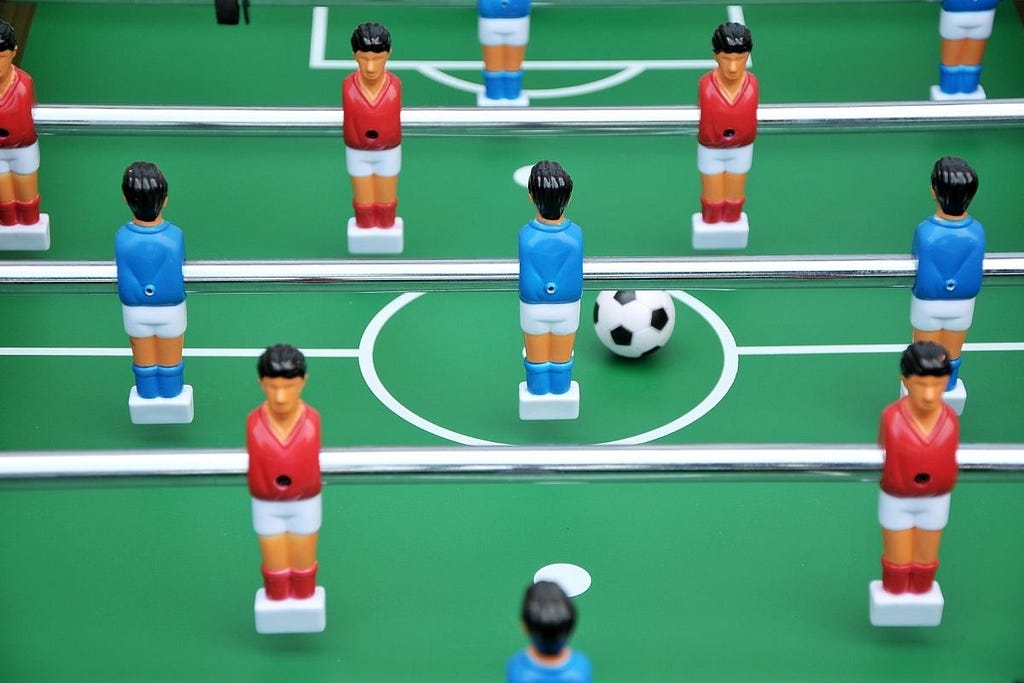 Players on a foosball table