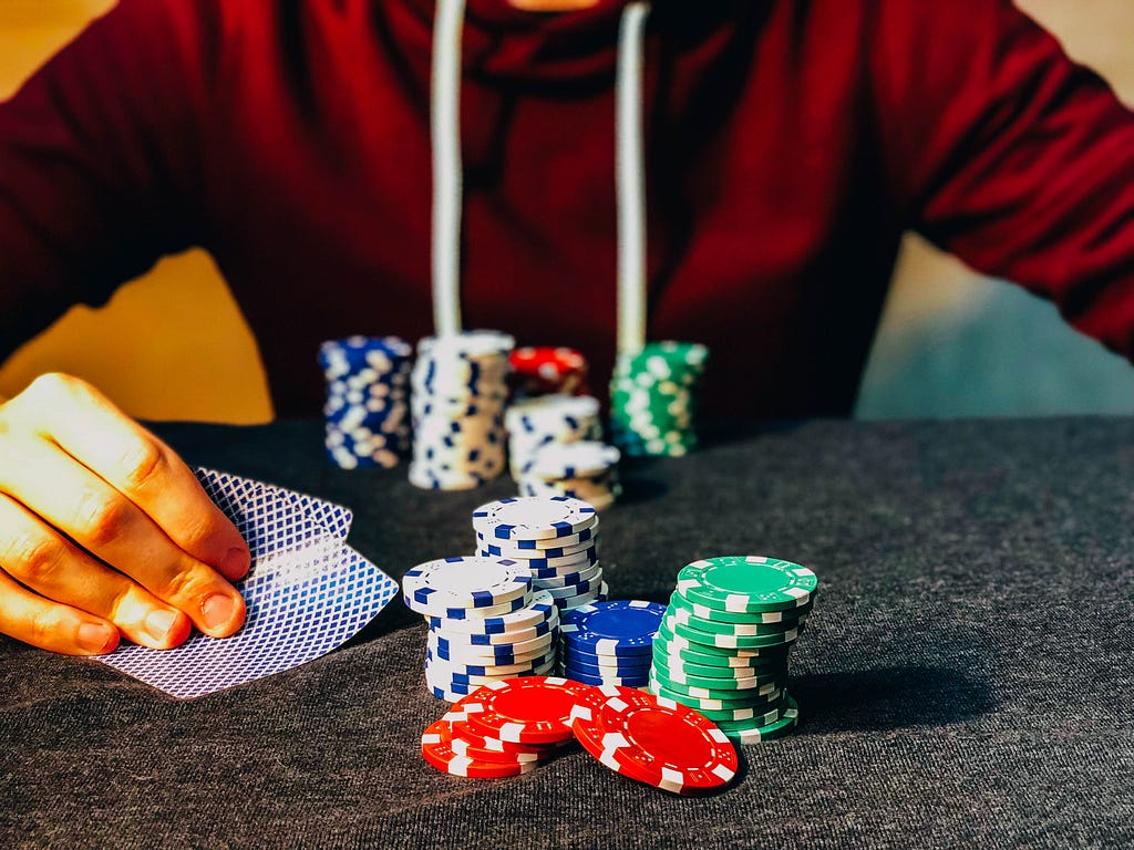 A person playing poker and about to unravel his cards