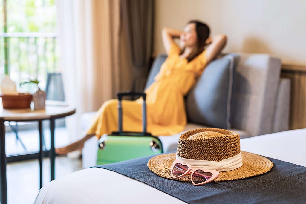 Happy Woman Relaxing in Resort Room — xTripz