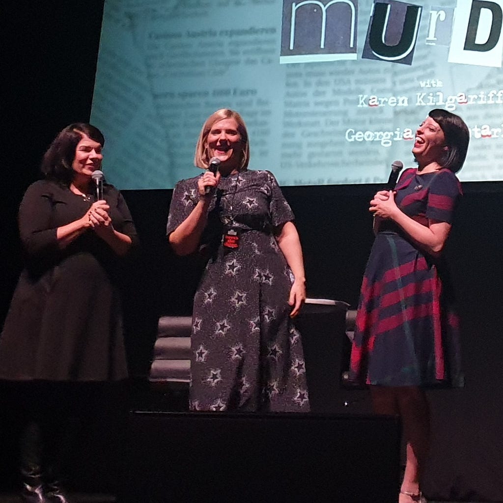 Karen Kilgariff, Olivia Standbridge and Georgia Hardstark on stage at the Hammersmith Apollo laughing.