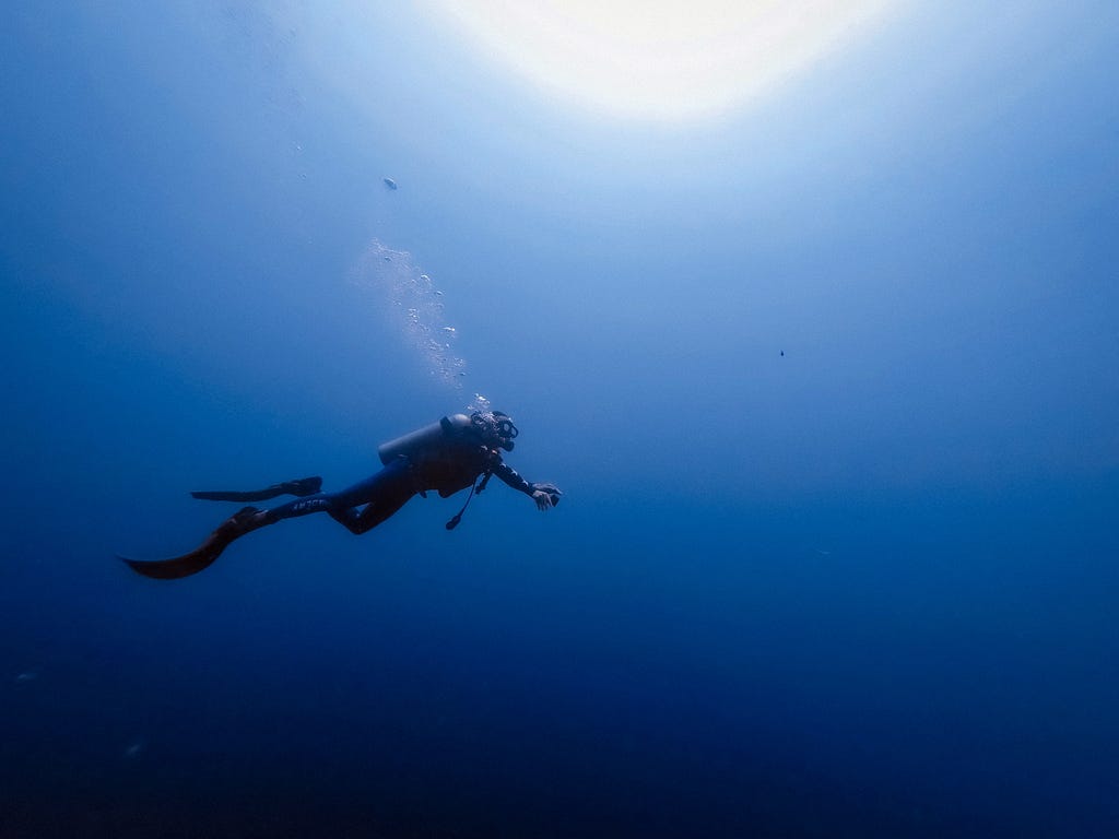 Person diving in the ocean.