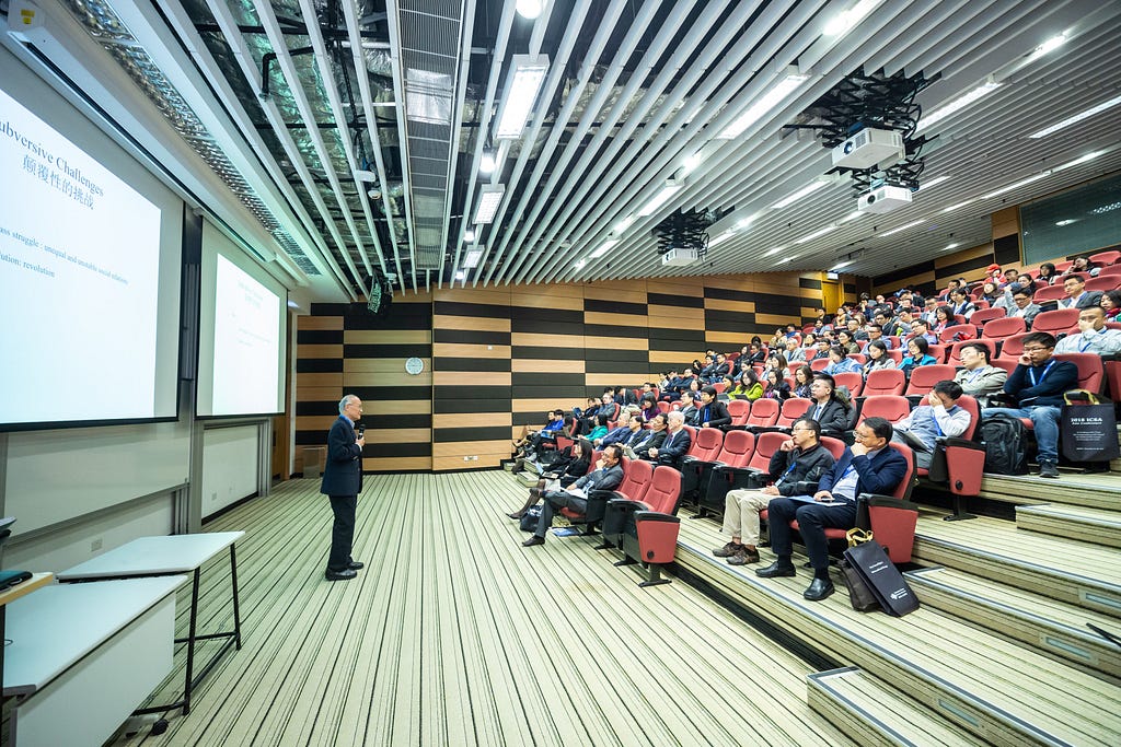 A person speaking in front of an audience