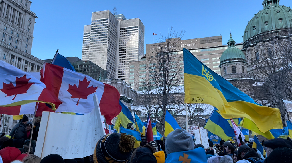 Canadian and Ukrainian flags are waved at the demonstration in solidarity with Ukraine in Montreal