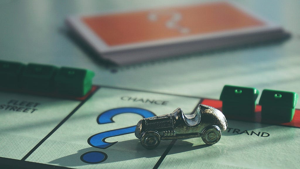 monopoly car figure on monopoly board