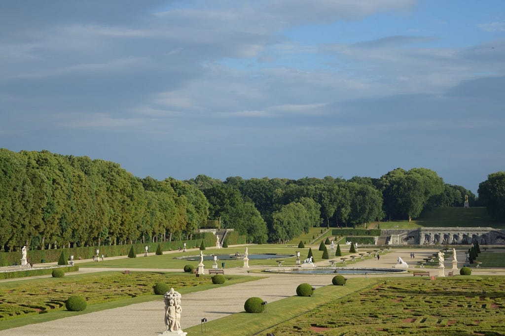 The statues, hedges, ponds, trees, alleys, and grotto of the grounds of the Château de Vaux-le-Vicomte.