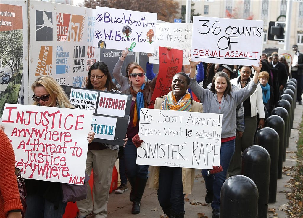 A large group of protestors carry signs outside the courthouse as the jury deliberates in the trial of Daniel Holtzclaw, in Oklahoma City on Dec. 8, 2015. Signs read: “Injustice anywhere is a threat to justice everywhere”, “Yo Acott Adams! Guess what is actually sinister rape”, “36 counts of sexual assault”, “#blackwomenmatter #webelieveyou”