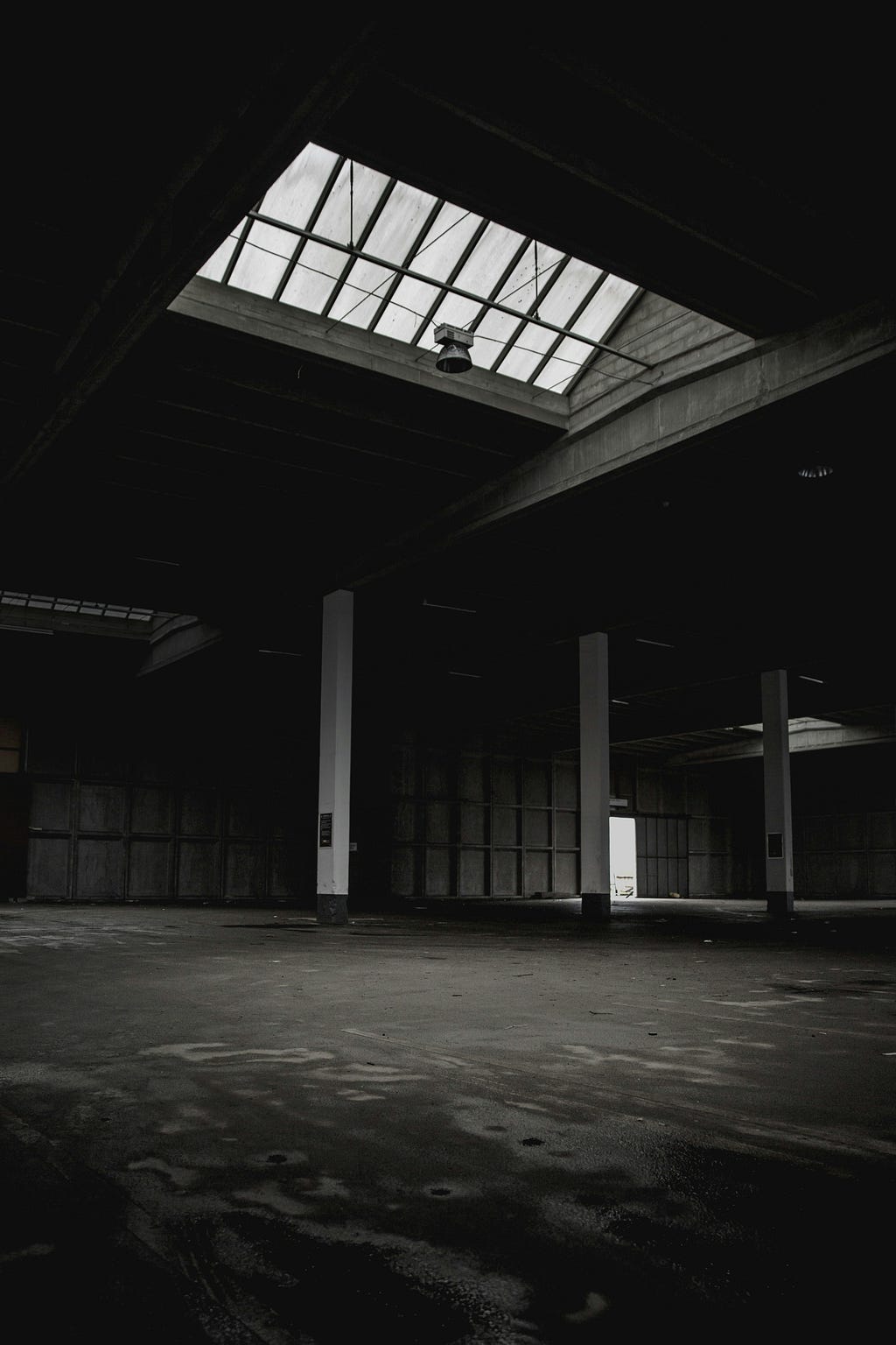 An empty, poorly lit warehouse.