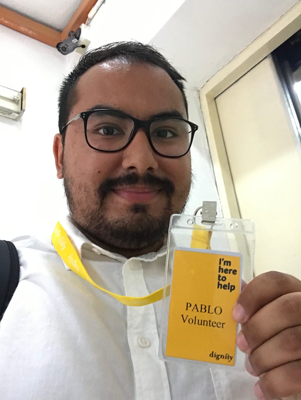 Picture of author holding a volunteer ID card