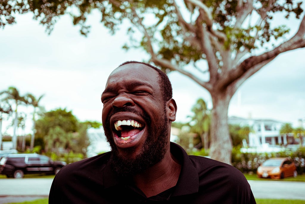 A Black man laughing.