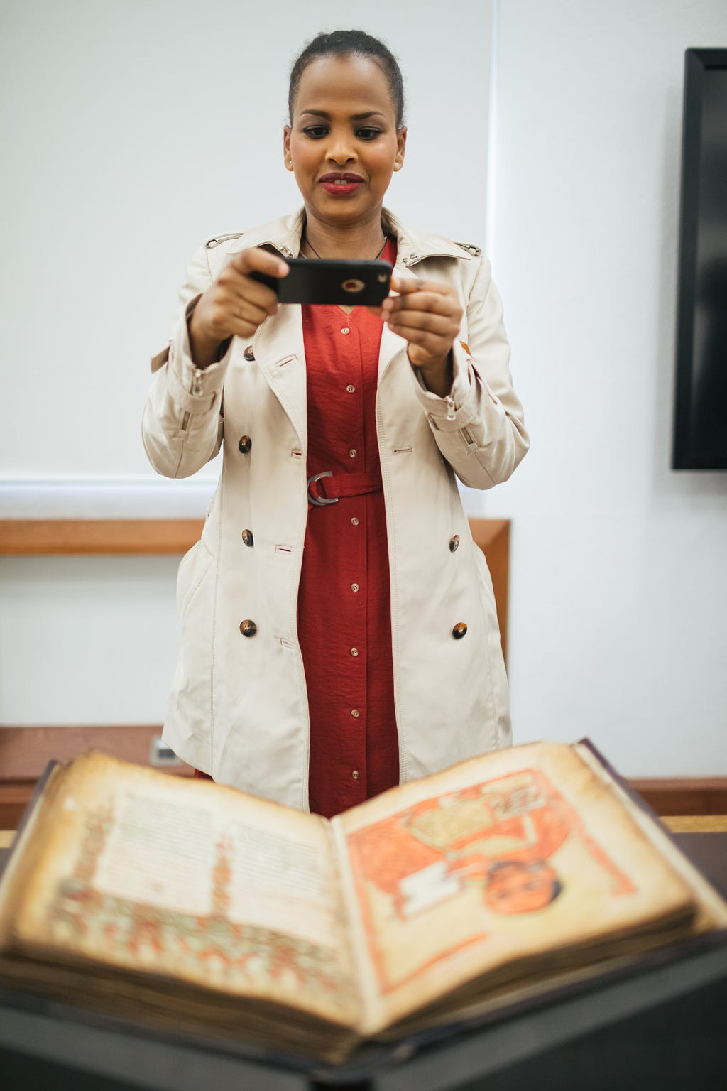 A woman takes a picture of a manuscript