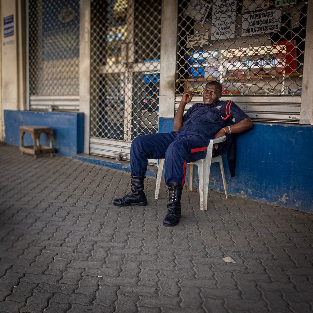 A guard siting on a chair.