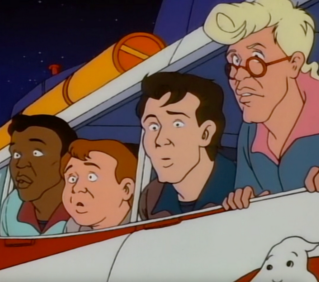 A still from The Real Ghostbusters cartoon, showing the four main characters leaning out of the windows of Ecto-1.