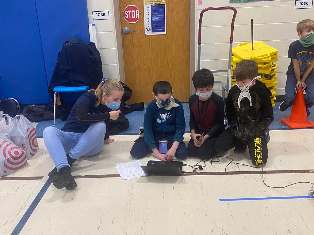 Me assisting students with coding activities from Norwood Park Elementary during the Lego Robotics Field Day event, November 2021