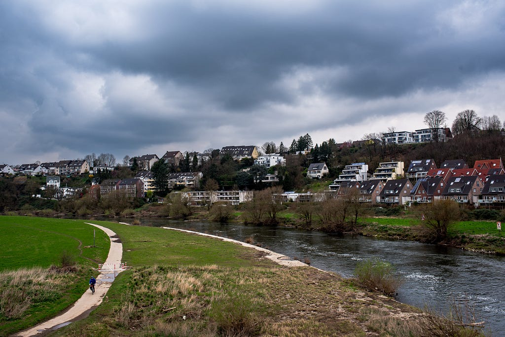 A cyclist passes on the southern Ruhr River path. Hattingen, Germany, March 18, 2024.