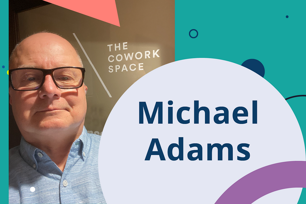 Photo of Michael Adams, with The Cowork Space banner in background