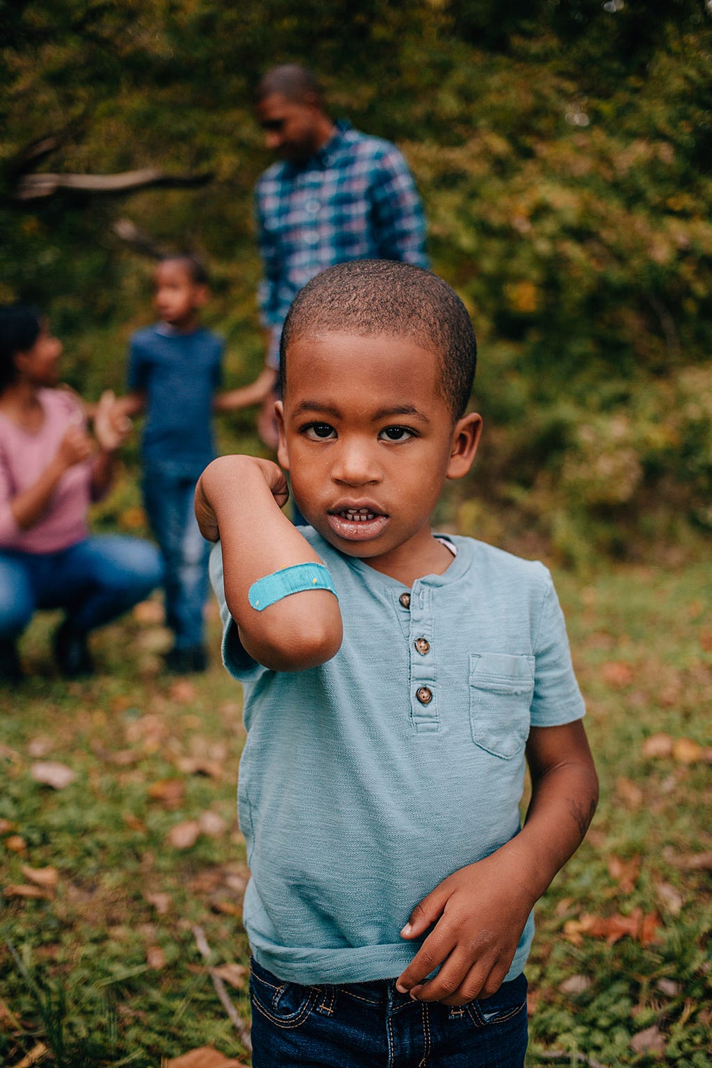 A boy with a band aid on his arm.