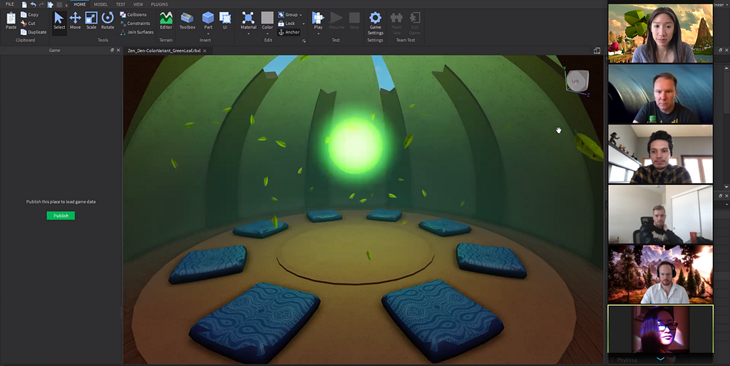 designers are collaborating on camera with a screenshot of a 3D rendered Zen Den: 8 sitting mats with a centered glowing orb