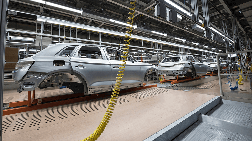 Partially constructed cars on an assembly line.